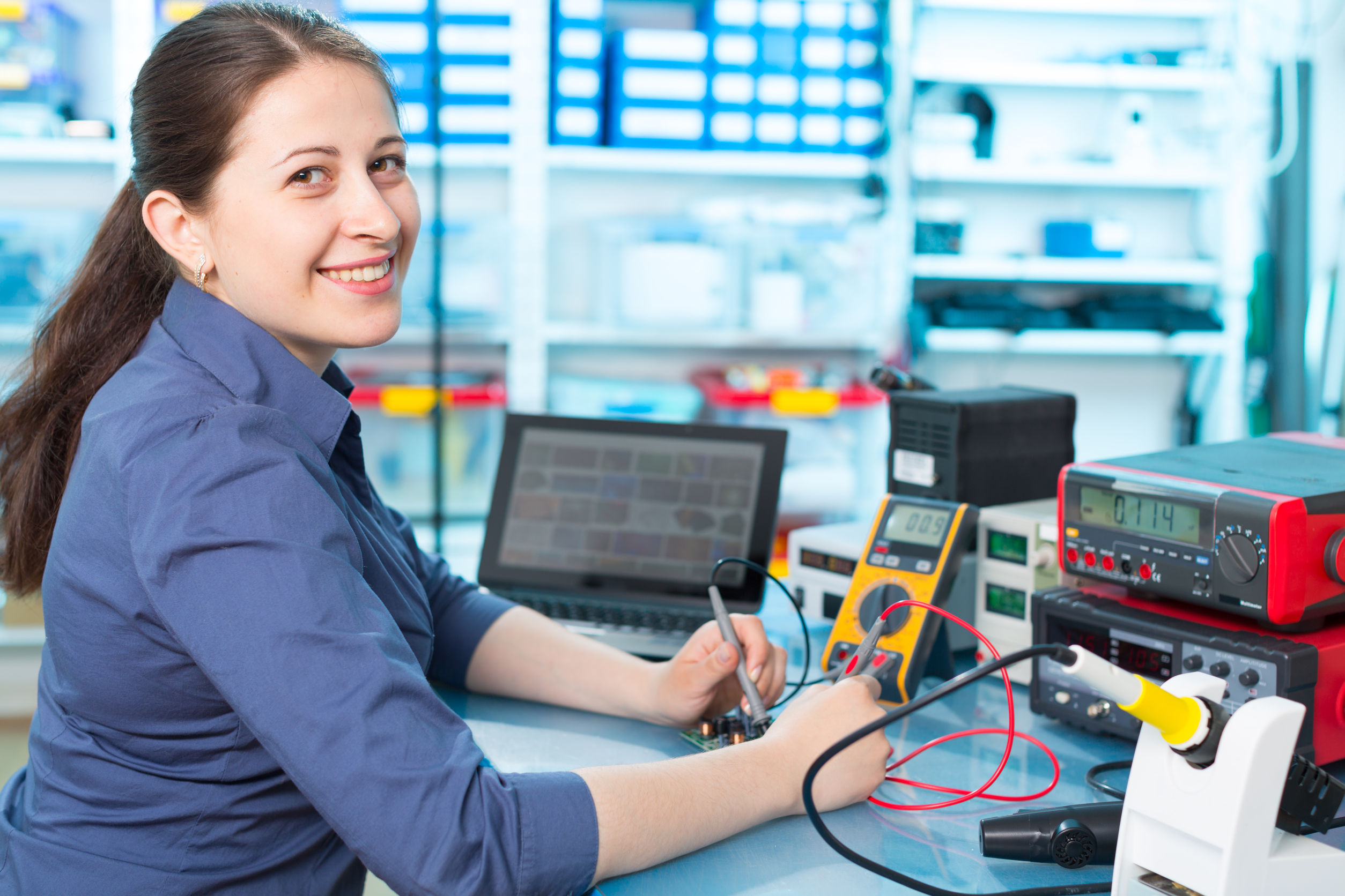 40455505 – woman with a tester and a printed circuit board